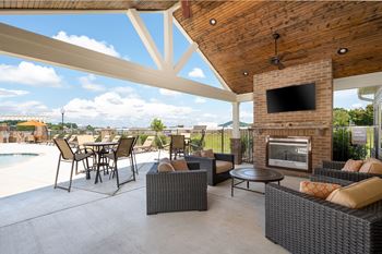 Outdoor pavilion with fireplace, flat screen tv, and food area